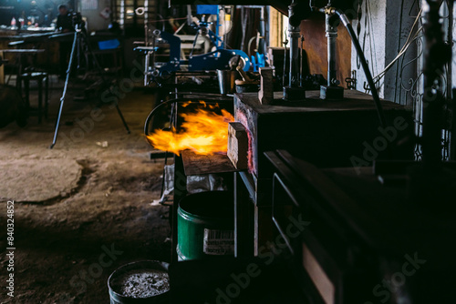 Traditional blacksmith workshop with fiery forge photo