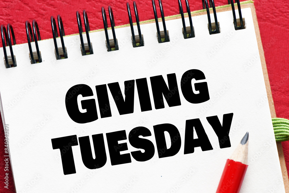 Fototapeta premium Giving Tuesday - words in an office notebook on red