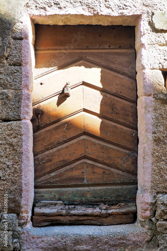 Old and solid solid wood door of a house in the town of Sartene, which according to Prosper Mérimee, was 