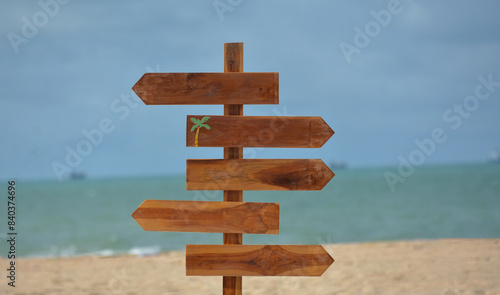 Fototapeta Naklejka Na Ścianę i Meble -  The background image is of a beach and a road sign.