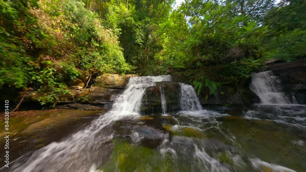 Smooth FPV flight over cascading river in a tropical rainforest in Thailand Smooth FPV flight over cascading river in a tropical rainforest in Thailand