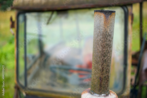 An old farm tractor. View of headlights, engine and cabin