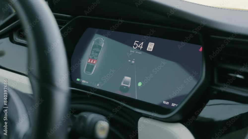 A close-up view of a car's dashboard display highlighting the speed and navigation system. The digital screen shows the vehicle's current speed, the speed limit, and navigation details. The interior A close-up view of a car's dashboard display highlighting the speed and navigation system. The digital screen shows the vehicle's current speed, the speed limit, and navigation details. The interior