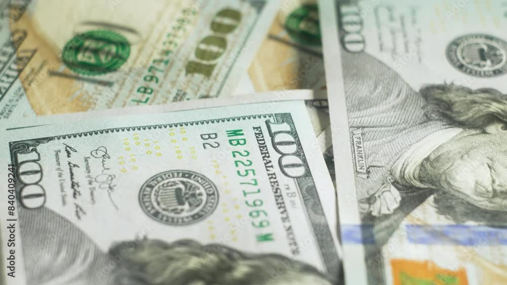 Dollars web, money background. Macro view USD currency banknotes, finance. Background with new sample of one hundred dollar bills on rotating platform. Stack of money Dollars web, money background. Macro view USD currency banknotes, finance. Background with new sample of one hundred dollar bills on rotating platform. Stack of money