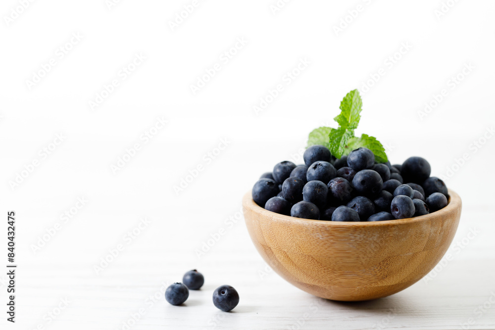 Ripe organic blueberries on white wooden table background. Selective focus. Ripe organic blueberries on white wooden table background. Selective focus.