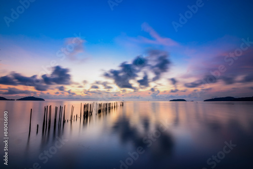 Twilight sky in the morning with the reflection of bamboo in the sea