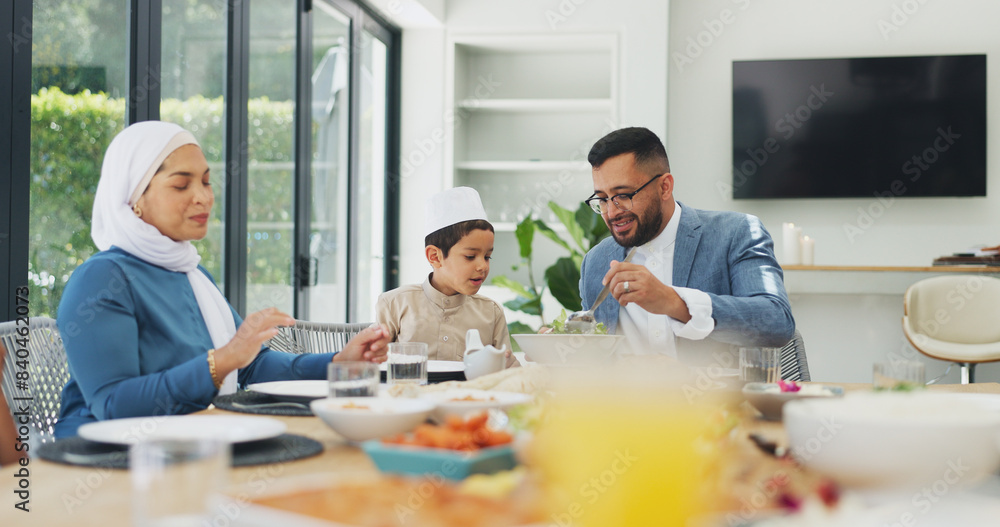 Obraz premium Islamic, family and dinner at dining table for ramadan, muslim celebration and eating food at home. Eid mubarak, culture and religious gathering with mother, father and son for bonding in apartment
