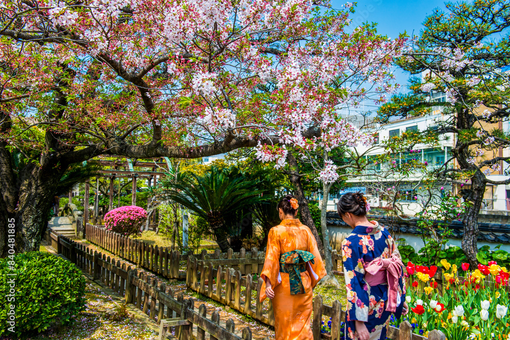 Traditionally dressed women in Dejima, a man made island in the port of Nagasaki, Kyushu Traditionally dressed women in Dejima, a man made island in the port of Nagasaki, Kyushu