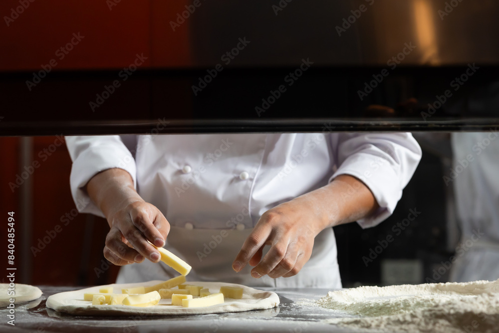 experienced chef - process of making pizza. Professional chef prepares the dough with flour to make pizza or pasta Italian food experienced chef - process of making pizza. Professional chef prepares the dough with flour to make pizza or pasta Italian food