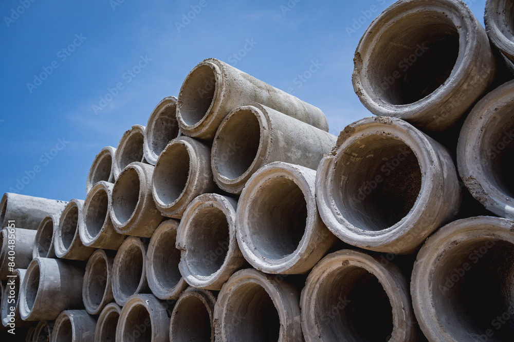 A stack of concrete ring pipes piled and creating a symmetrical arrangement A stack of concrete ring pipes piled and creating a symmetrical arrangement