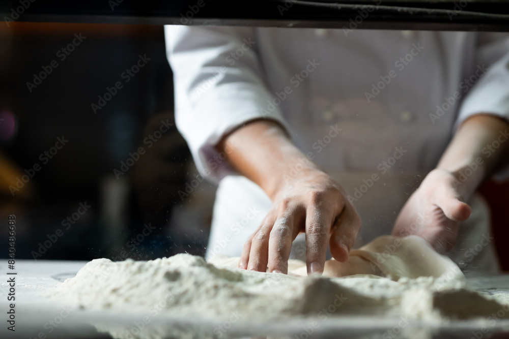 experienced chef - Professional chef prepares the dough with flour to make pizza or pasta Italian food experienced chef - Professional chef prepares the dough with flour to make pizza or pasta Italian food