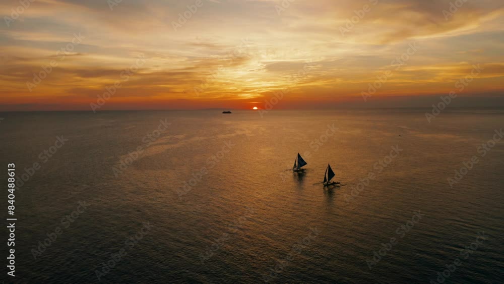 Sunset above the sea surface with sail boats, aerial view Boracay, Philippines. Reflected sun on a water surface. Sunset over ocean. Seascape, Summer and travel vacation concept Sunset above the sea surface with sail boats, aerial view Boracay, Philippines. Reflected sun on a water surface. Sunset over ocean. Seascape, Summer and travel vacation concept