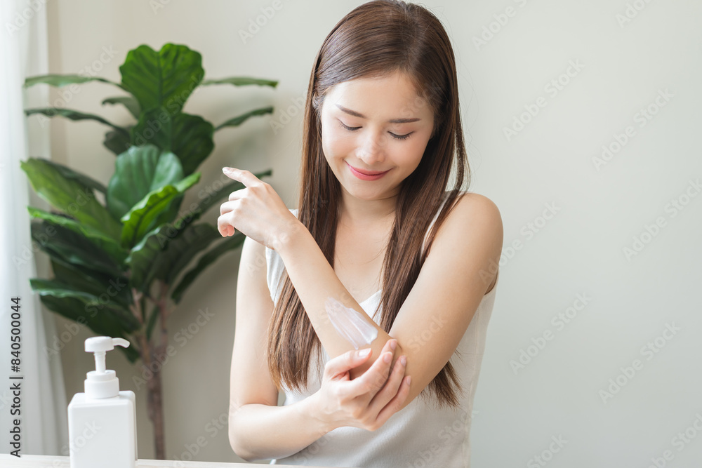Health skin care, beauty smile asian young woman, girl hand applying, putting moisturizer on her arm, shoulder after shower bath at home. Skin body cream moisturizing lotion, routine in the morning. Health skin care, beauty smile asian young woman, girl hand applying, putting moisturizer on her arm, shoulder after shower bath at home. Skin body cream moisturizing lotion, routine in the morning.