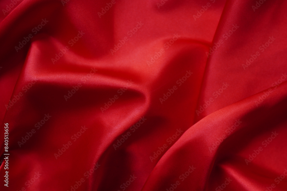 Fototapeta premium Texture red satin or silk is beautiful and luxurious (blurred)