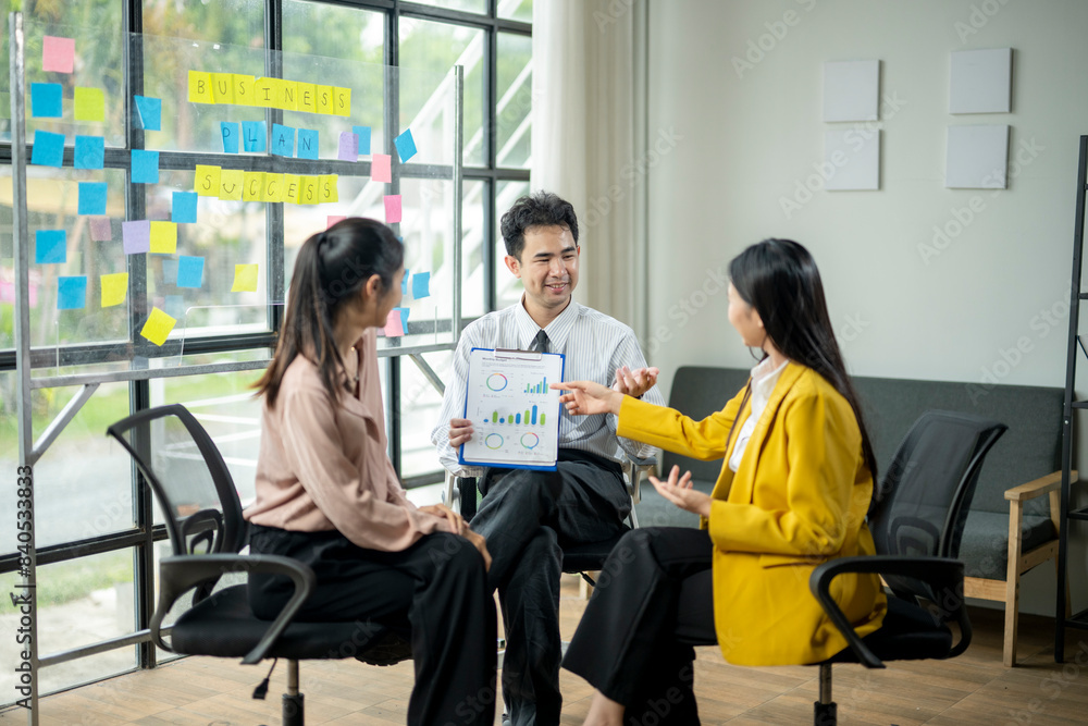 Three people are sitting in chairs in a room Three people are sitting in chairs in a room