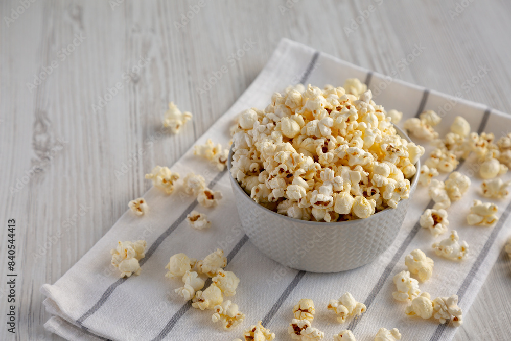 White Buttered Popcorn with Salt in a Bowl, side view. Space for text. White Buttered Popcorn with Salt in a Bowl, side view. Space for text.