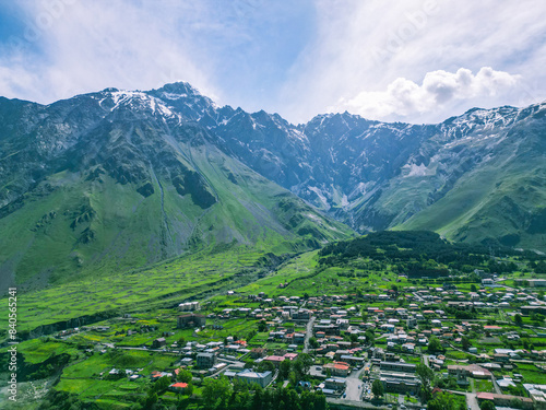  Stepantsminda tourist village of Kazbegi in the green mountains of Georgia - drone photo photo