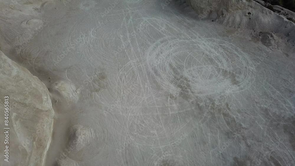 Aerial view of car tracks in white sand field. Natural abstract textured background. Drone footage. Aerial view of car tracks in white sand field. Natural abstract textured background. Drone footage.