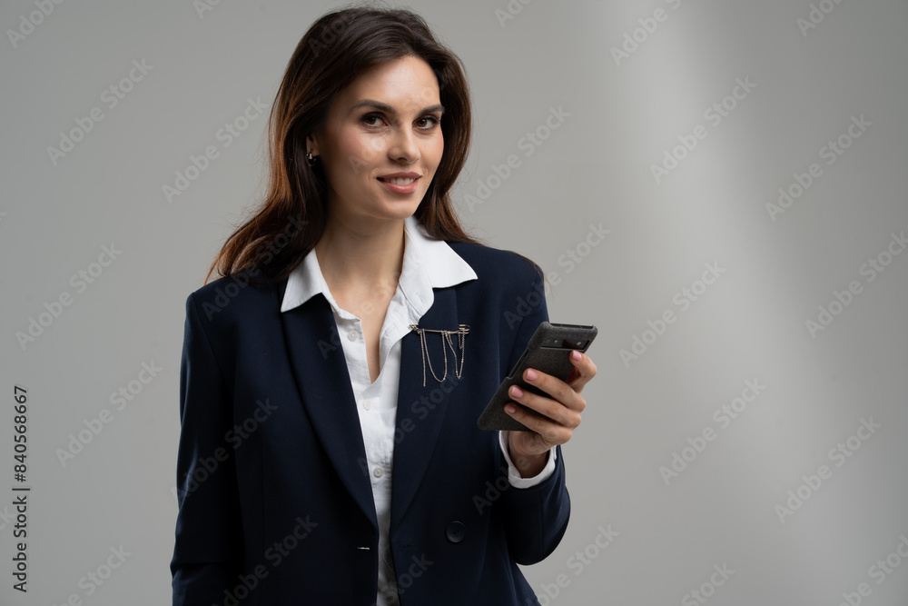 Businesswoman gesturing with her cellphone at an event Businesswoman gesturing with her cellphone at an event