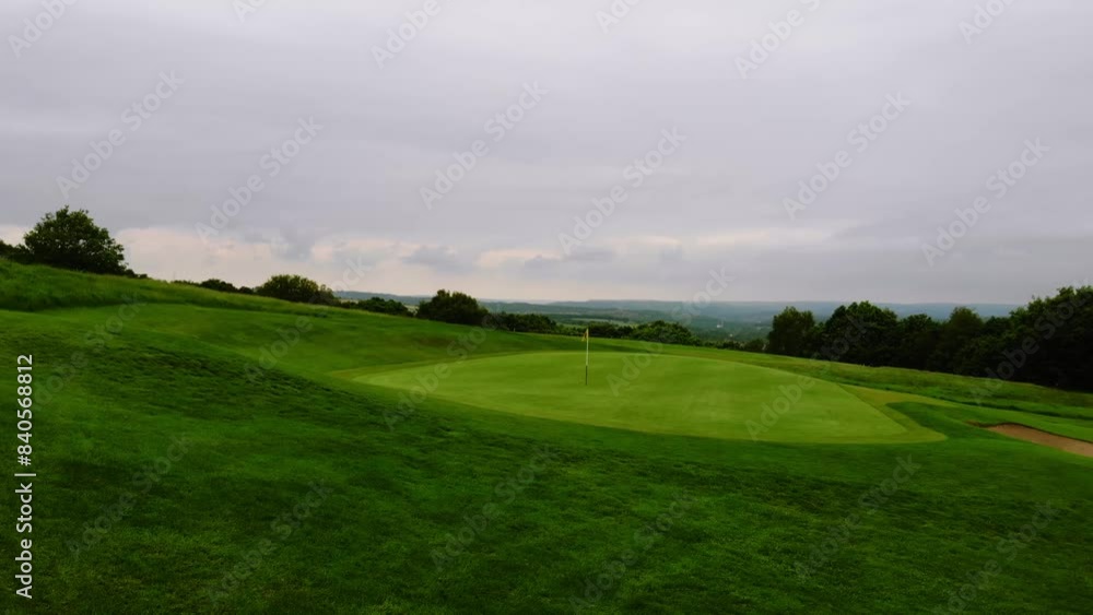 Golf course playing fields in England drone aerial wide shot Golf course playing fields in England drone aerial wide shot