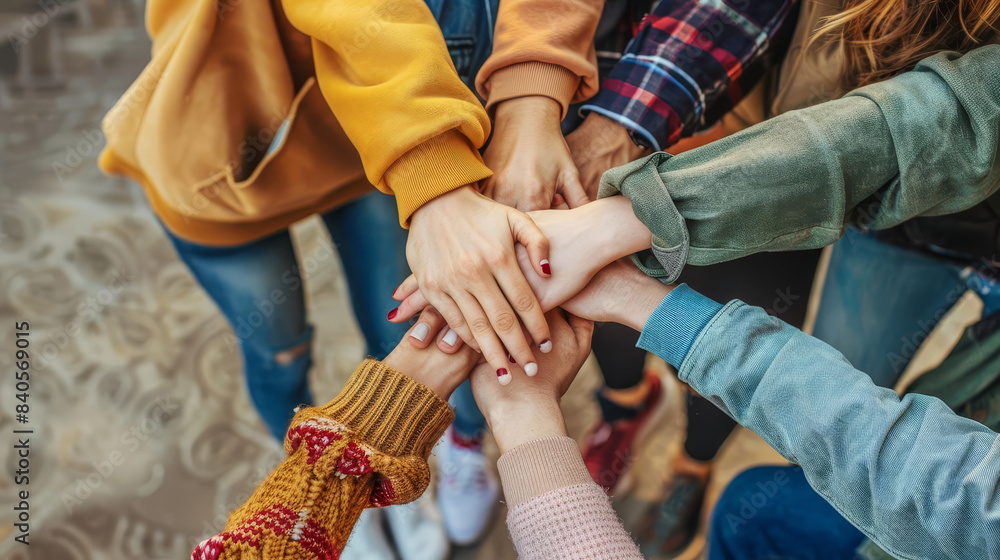 A group of friends stacking hands, represents support and teamwork in university life, with copy space A group of friends stacking hands, represents support and teamwork in university life, with copy space