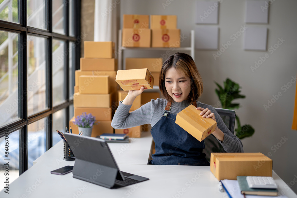 A woman is sitting at a desk with a box in front of her A woman is sitting at a desk with a box in front of her