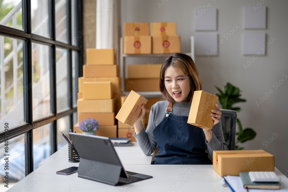 A woman is sitting at a desk with a box in front of her A woman is sitting at a desk with a box in front of her