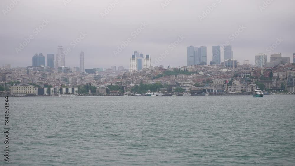 Boats sail on the Bosphorus with Istanbul cityscape, blending modern and historic architecture Boats sail on the Bosphorus with Istanbul cityscape, blending modern and historic architecture