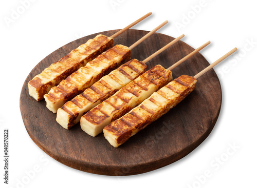 Grilled Rennet or Coalho cheese on a wooden board isolated over white background