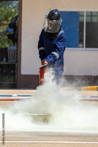 Bilde på lerret Firefighter using a fire extinguisher Spray fire extinguishing chemicals with a