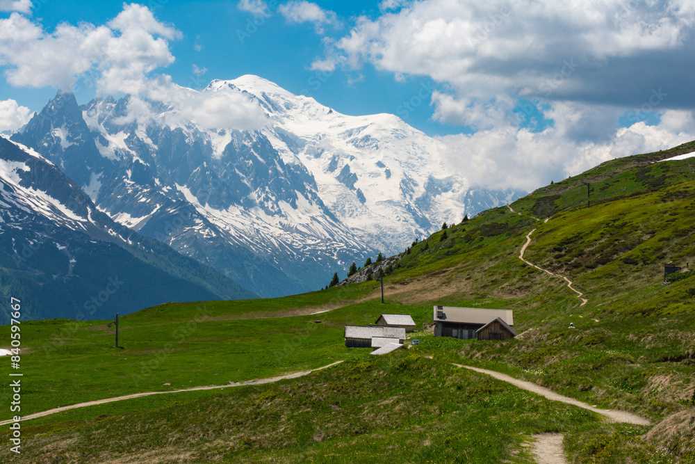 Picturesque panoramic view of the snowy Alps mountains and meadows while hiking Tour du Mont Blanc. Popular hiking route. Alps, Chamonix-Mont-Blanc region, France, Europe.