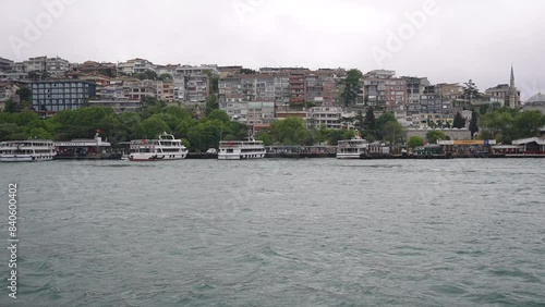 Enjoy the scenic cityscape waterfront as boats dock along the shore on a cloudy day photo