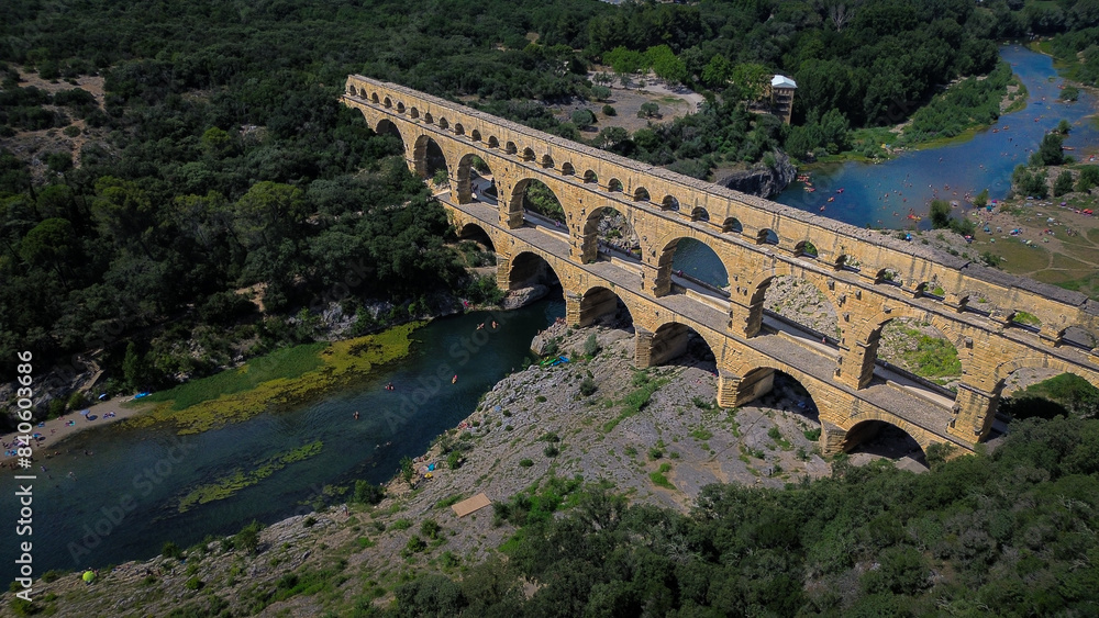 Fototapeta premium Aerial view of Pont du Gard, and ancient aqueduct Roman bridge infrastructure in the South of France.