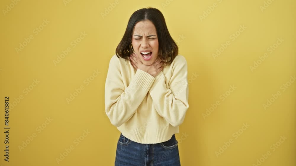 Young hispanic woman in pain, choking in her beautiful yellow sweater, isolate on background. health problem - violent asphyxiate, suffocate or strangle assault. Young hispanic woman in pain, choking in her beautiful yellow sweater, isolate on background. health problem - violent asphyxiate, suffocate or strangle assault.