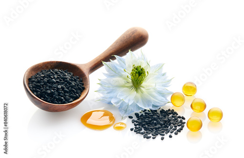 Black cumin seeds and capsules with nigella sativa flower on white background