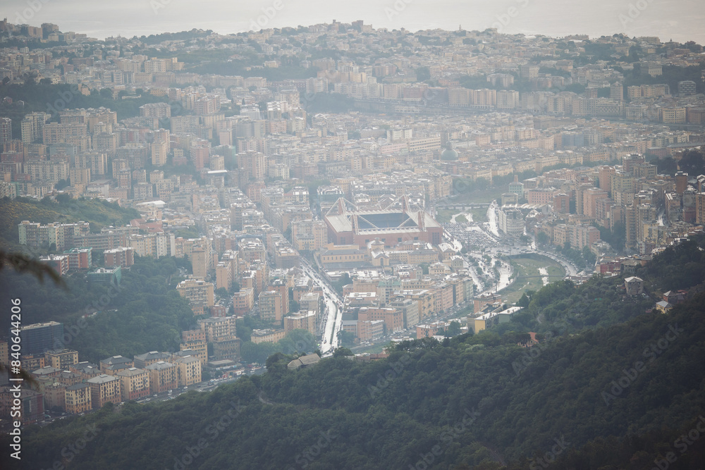 Fototapeta premium foggy Genova town, Italy, aerial view. Beautiful aerial view of Val Bisagno, Marassi district, Bisagno river and Stadio Luigi Ferraris football stadium, home of Genoa and Sampdoria football clubs