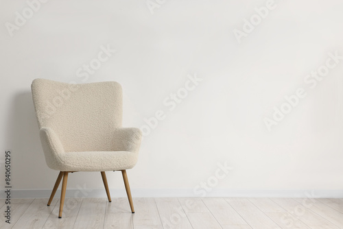 Comfortable armchair near white wall in room  space for text