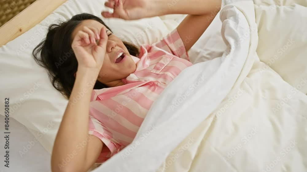 A young hispanic woman waking up, rubbing eyes in her bedroom, exuding morning freshness A young hispanic woman waking up, rubbing eyes in her bedroom, exuding morning freshness