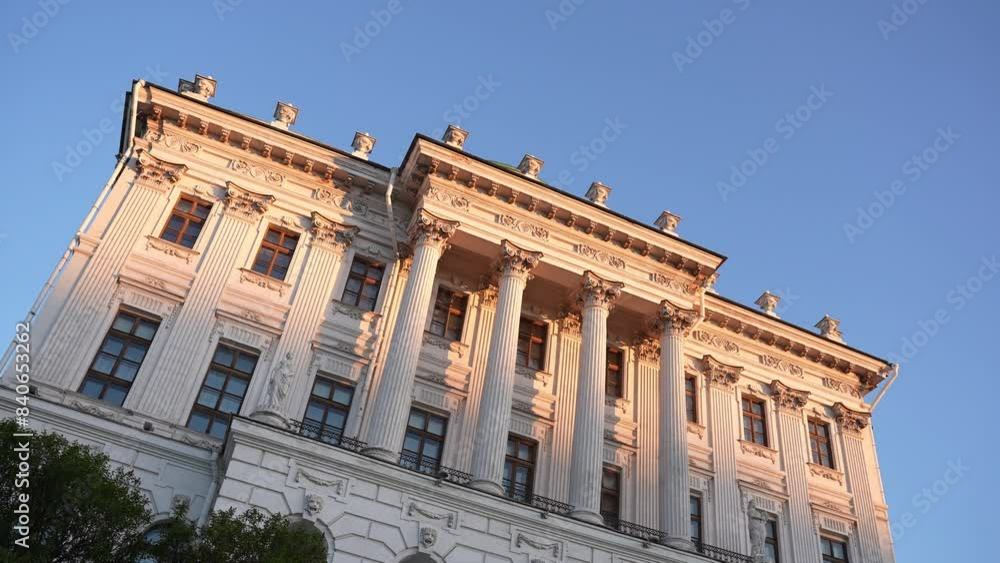 The sunset illuminates a stunning old building with Corinthian columns, creating a picturesque view The sunset illuminates a stunning old building with Corinthian columns, creating a picturesque view