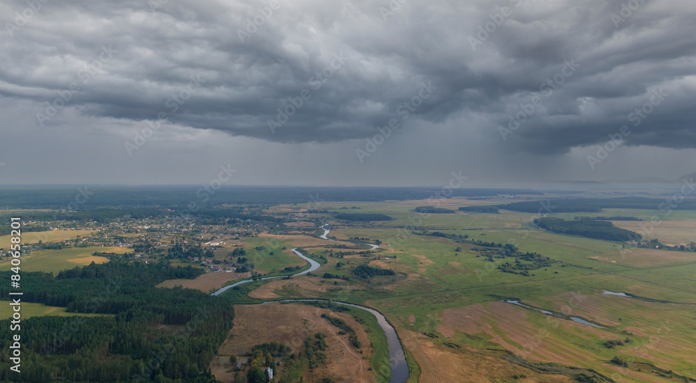 Panorama view from above of the summer landscape. Orange sunset sky, fields and forests, rivers and roads Panorama view from above of the summer landscape. Orange sunset sky, fields and forests, rivers and roads