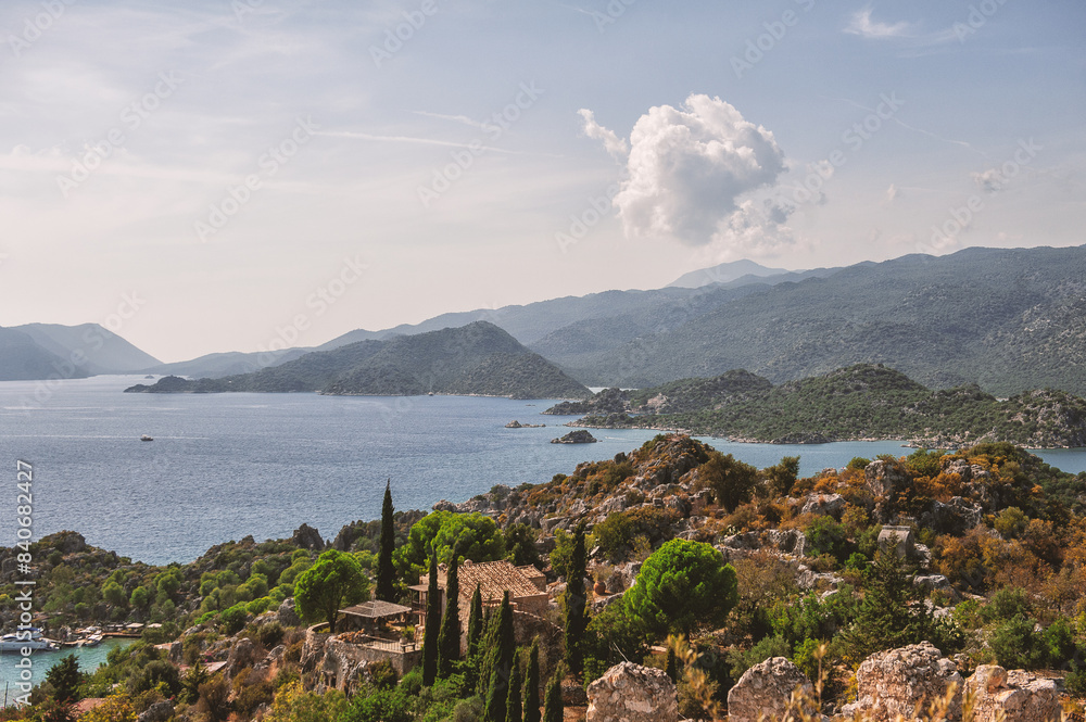 Beautiful atmospheric landscape with blue sea, forest hills, sunny sky and old town Beautiful atmospheric landscape with blue sea, forest hills, sunny sky and old town