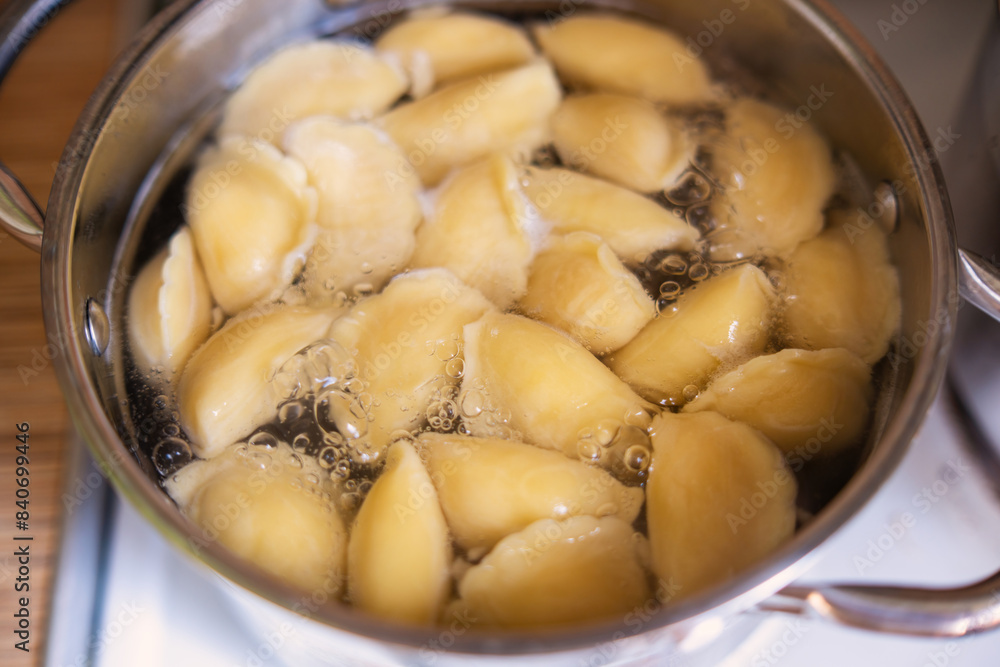 Vareniki dumplings boiling in a pot, capturing the essence of traditional Slavic cuisine Vareniki dumplings boiling in a pot, capturing the essence of traditional Slavic cuisine