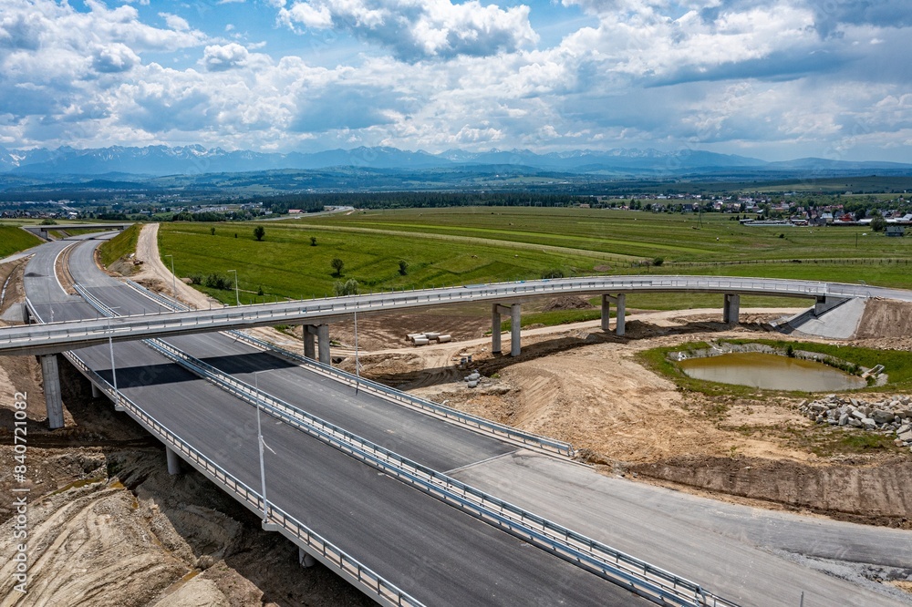 Drone shot of the highway construction from Krakow to Zakopane in the summer. The road will lead into the Polish Tatra Mountains.