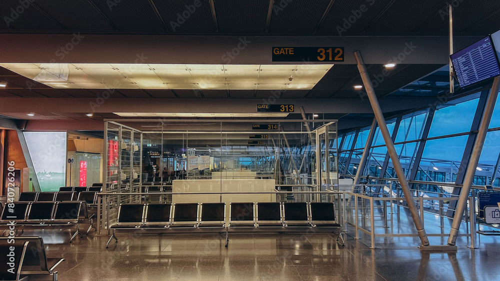 An empty terminal, aircrafts are waiting and preparing for their next flight and one of them taken off An empty terminal, aircrafts are waiting and preparing for their next flight and one of them taken off