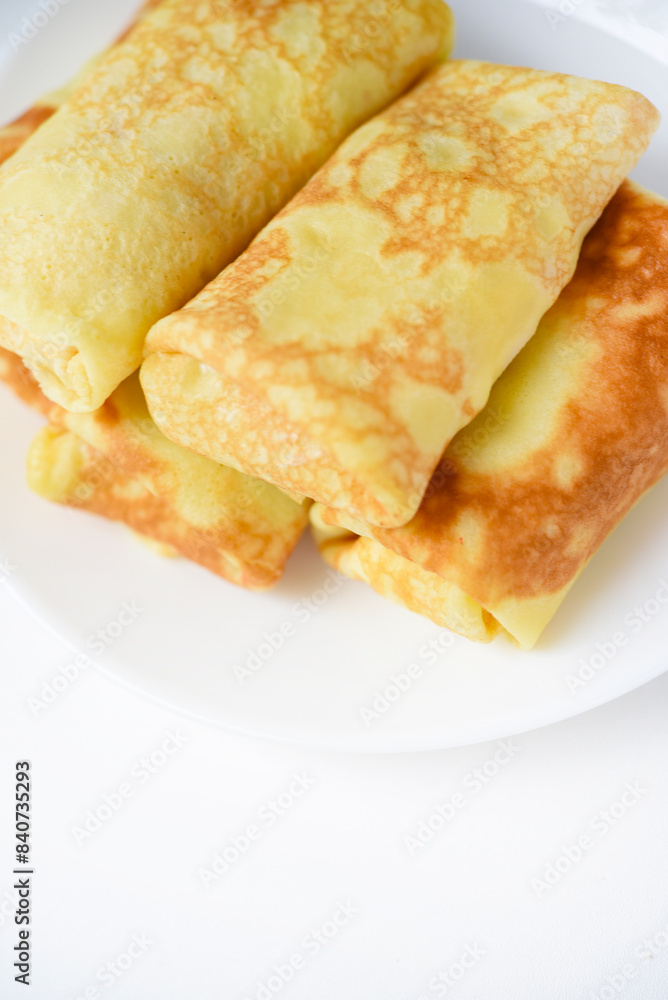 Pancakes with meat on a plate. Delicious envelopes with meat. Pancakes with meat on a plate. Delicious envelopes with meat.