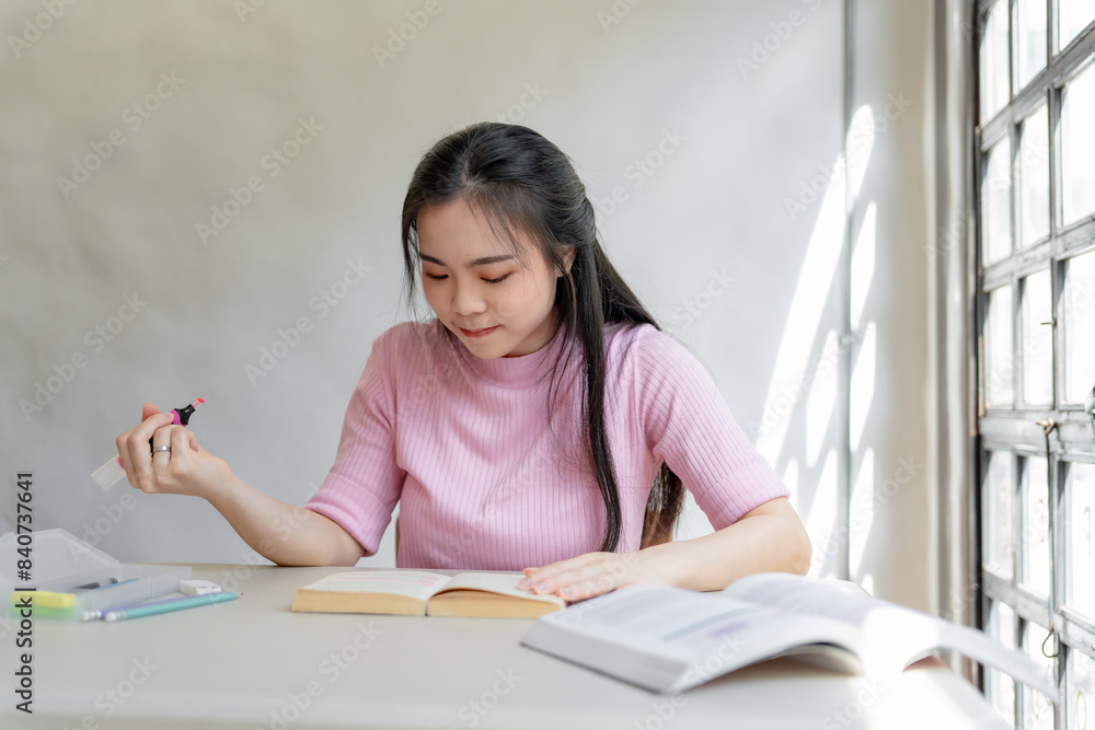 Asian girl student reading book preparing for college exam Young female student studying and writing on notebook making in school library Asian girl student reading book preparing for college exam Young female student studying and writing on notebook making in school library