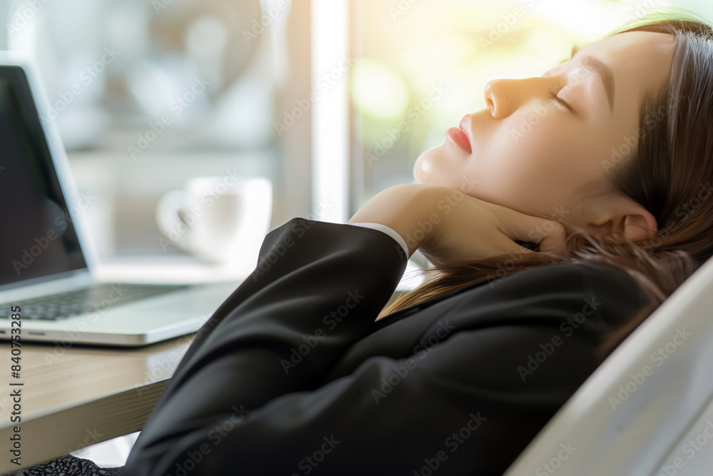 Tired professional woman asleep at desk, with a laptop nearby, workplace stress Tired professional woman asleep at desk, with a laptop nearby, workplace stress