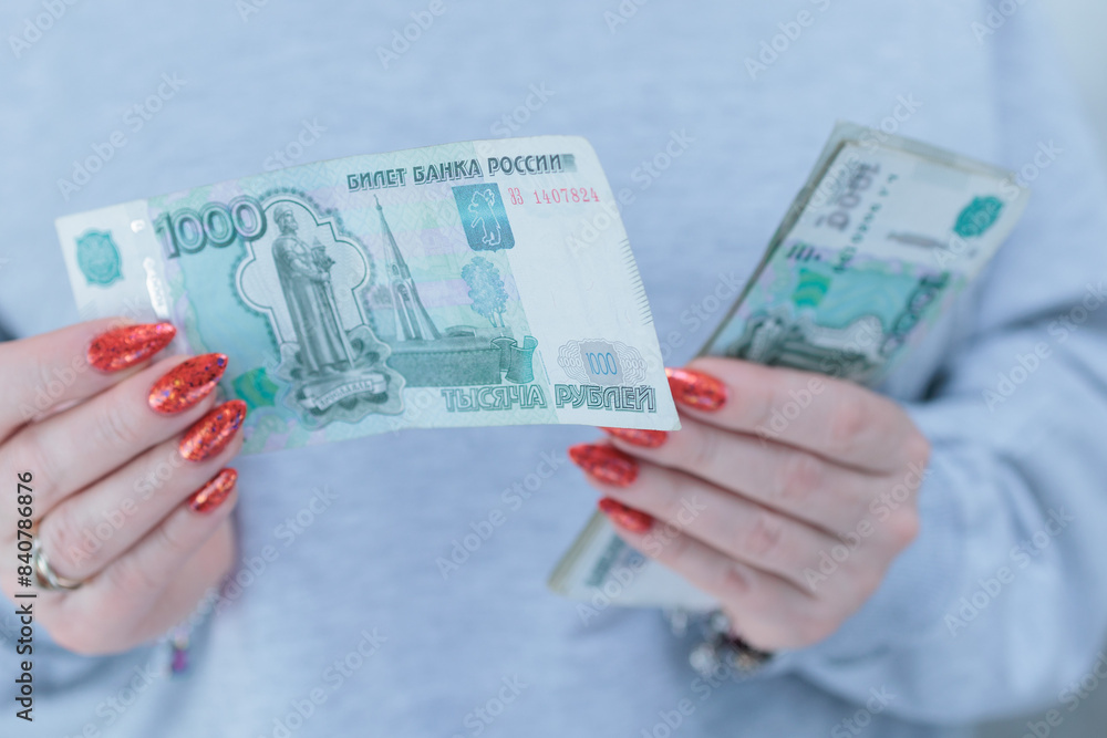 Female hands holding paper bills in Russian rubles Female hands holding paper bills in Russian rubles