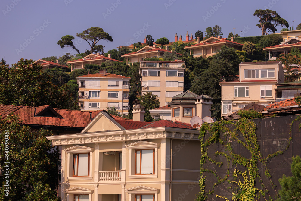 Fototapeta premium Southern cityscape, view of buildings and houses with green plants in public places in Turkey, sunny summer day in the city of Istanbul