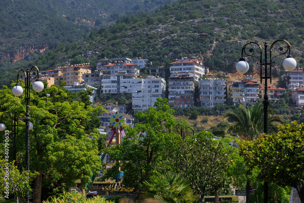 Fototapeta premium Southern cityscape, view of buildings and houses with green plants in public places in Turkey, sunny summer day in the city of Istanbul
